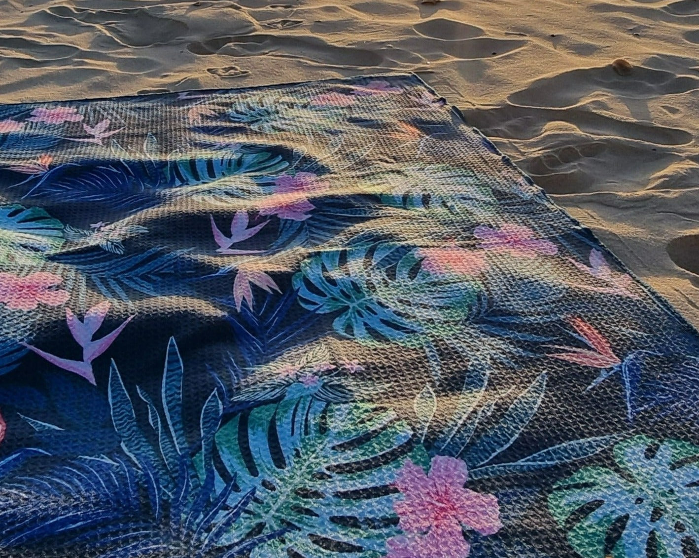 Sand free beach towel on the sand at dusk