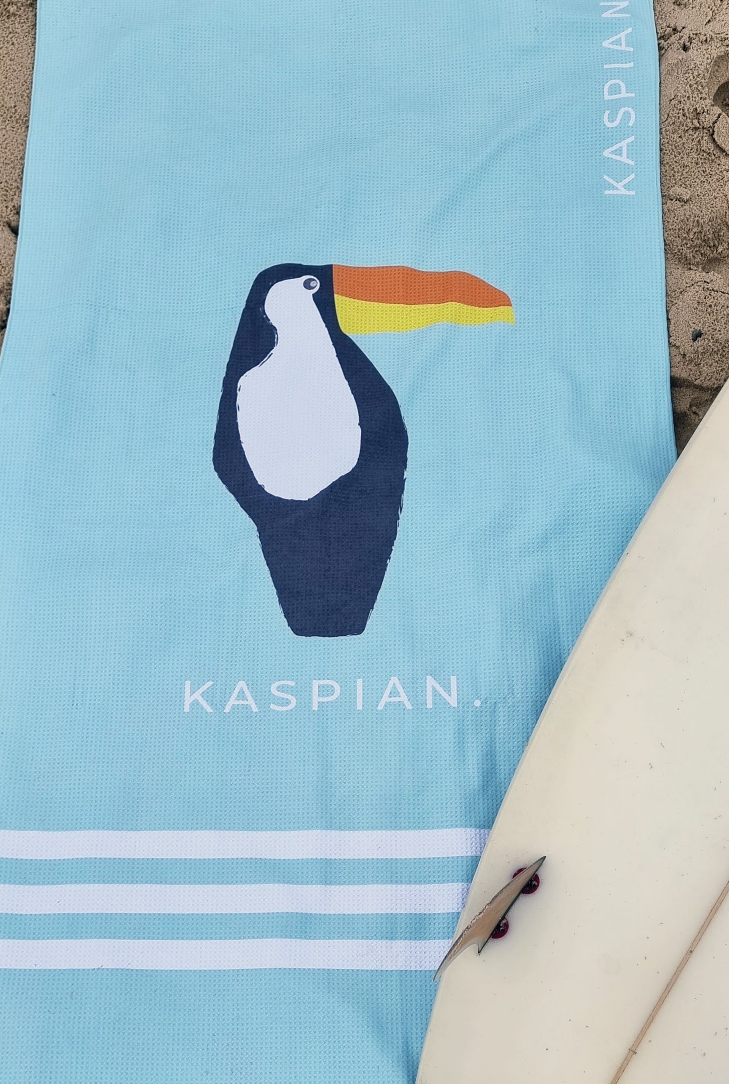 Surfboard and beach towel with Toucan design by Kaspian