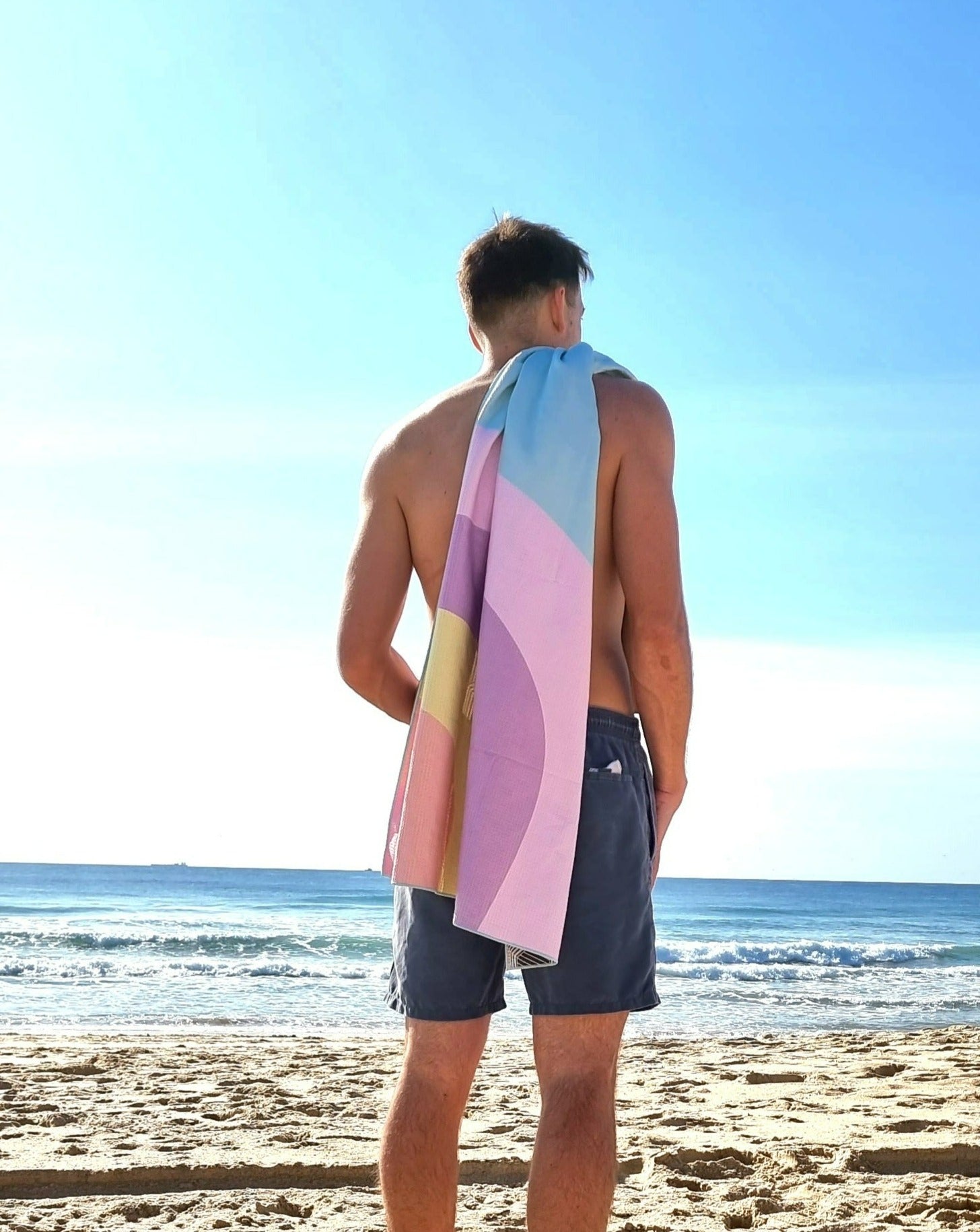 Byron sand free beach towel with man on beach