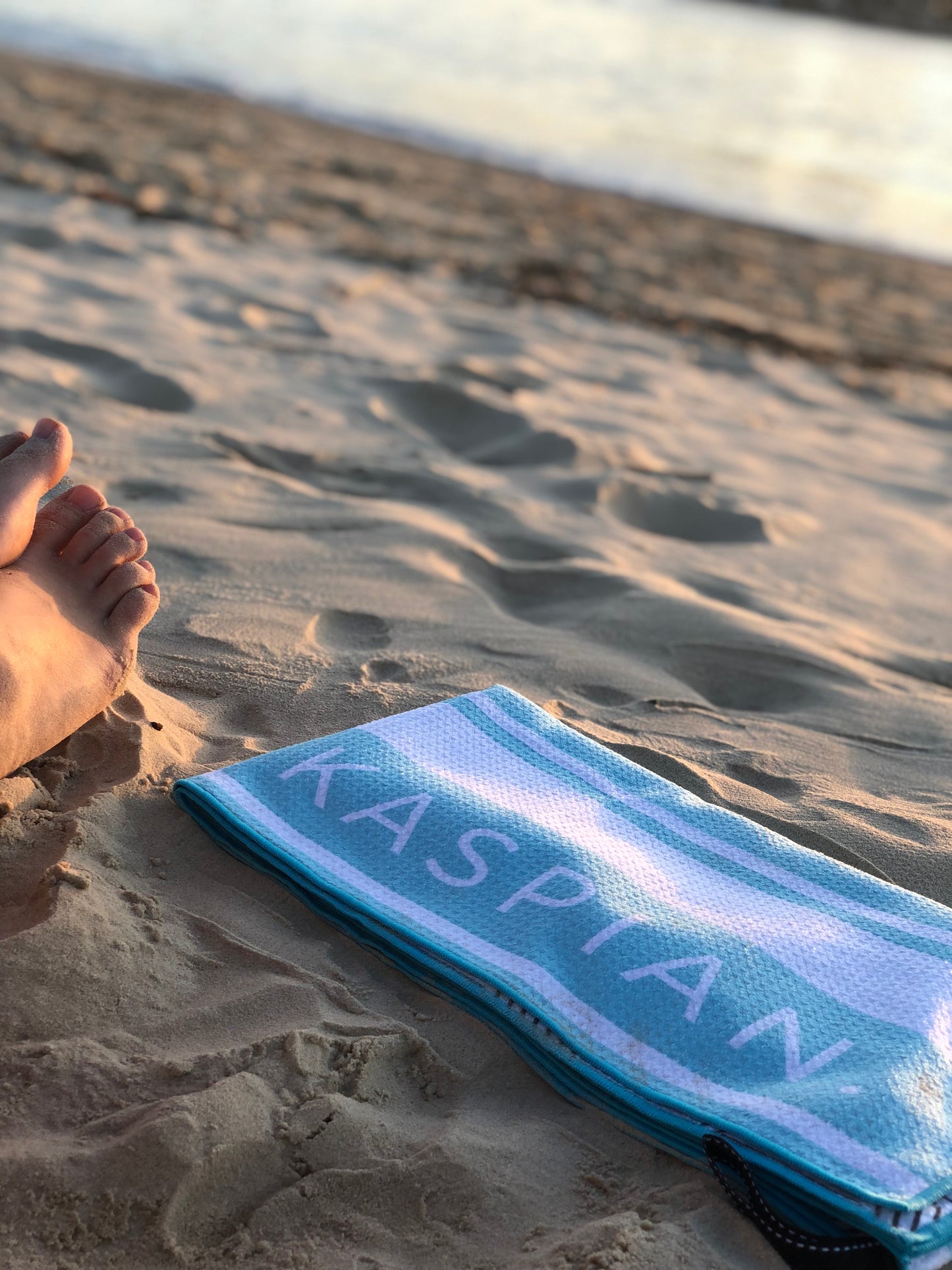 Cloud break sand free towel at the beach