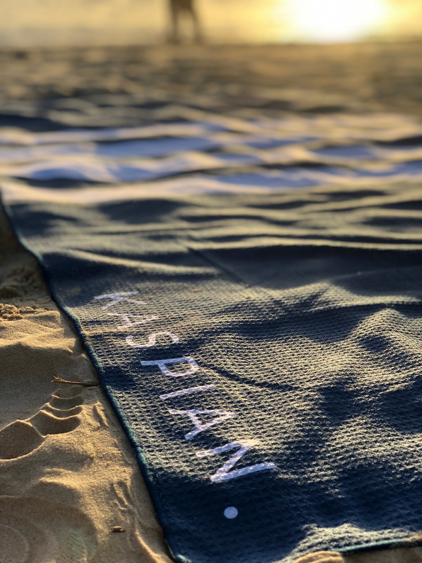 Kaspian branded beach towel made from sand free material